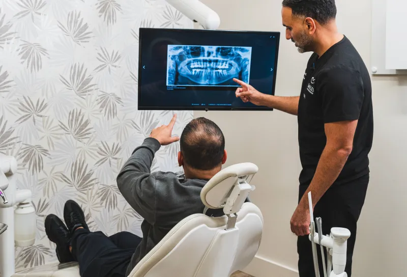 Dentist talking a patient through their treatment plan at Smiles Family Dentistry